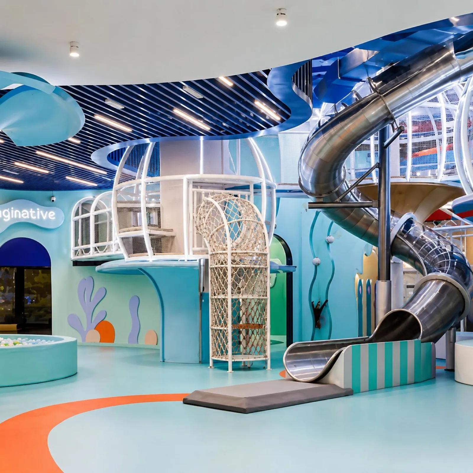 Indoor theme park with slides and imaginative play structures